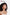 Woman with curly hair wearing a white top against a plain background with 'u flawless' text. TR