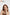 Woman with red hair wearing a gold necklace against a white background, with 'uglowy' branding. TR