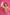 Woman in a pink robe holding a bottle of 'uLOOK' product against a pink background TR