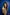 Woman holding a 'uLOOK' product against a blue tiled wall TR
